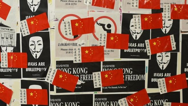 Chinese flags are seen on the wall of a tunnel in the Tsim Sha Tsui district in Hong Kong on October 1, 2019