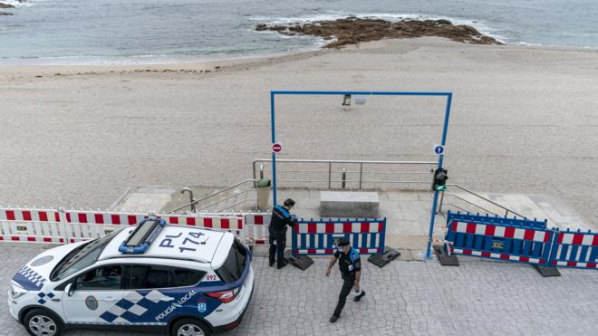 The local police cordon off access to Riazor beach on June 23, 2020 in A Coruna, Spain.