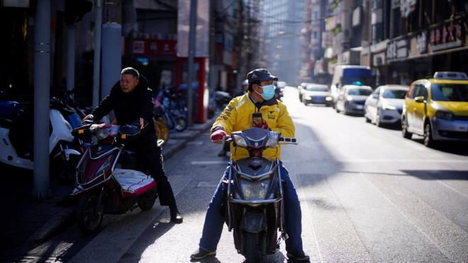 A Meituan delivery worker wearing a face mask is seen on a street following an outbreak of the coronavirus disease (COVID-19) in Shanghai, China January 13, 2021.