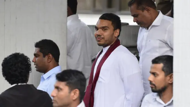 Namal Rajapaksa (C), son of former Sri Lankan president Mahinda Rajapaksa, leaves the Supreme Court in Colombo on December 14, 2018. - Sri Lanka's Supreme Court opened the way for potential impeachment proceedings against President Maithripala Sirisena on December 13, ruling that he broke the law by dissolving parliament last month.