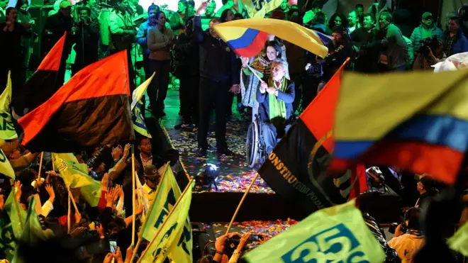 Lenin Moreno (centre) has begun celebrating with his supporters