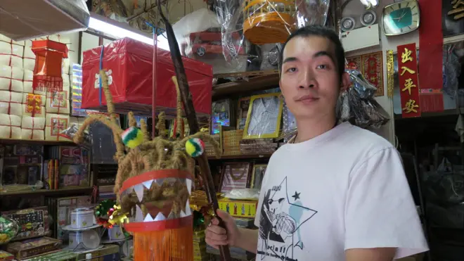 欧阳秉志拿着一件试作龙头作品（BBC中文网图片）