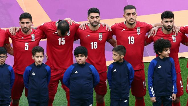 Iran players standing in silence during the national anthem