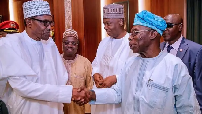 President Muhammadu Buhari dey shake hand wit Olusegun Obasanjo