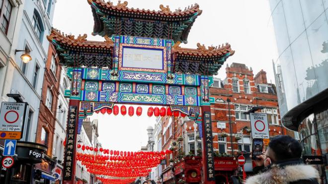 A person takes a picture of decorations set up for Chinese Lunar New Year in China Town, London, Britain February 11, 2021.
