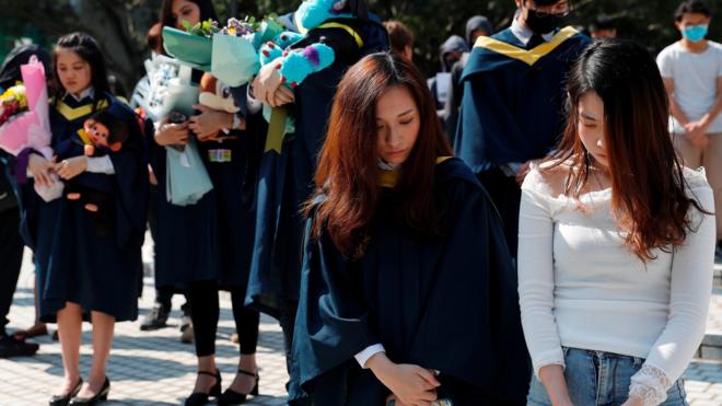 Graduates attend a ceremony to pay tribute to Chow Tsz-lok, 22, a university student who fell during protests at the weekend and died early on Friday morning