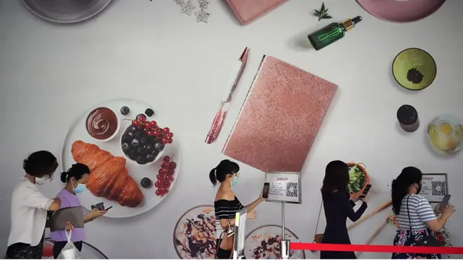 People queue up to scan contact tracing QR codes in Singapore's business district