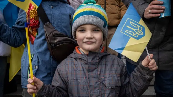 Un niño sonríe frente a la cámara en Kyiv.