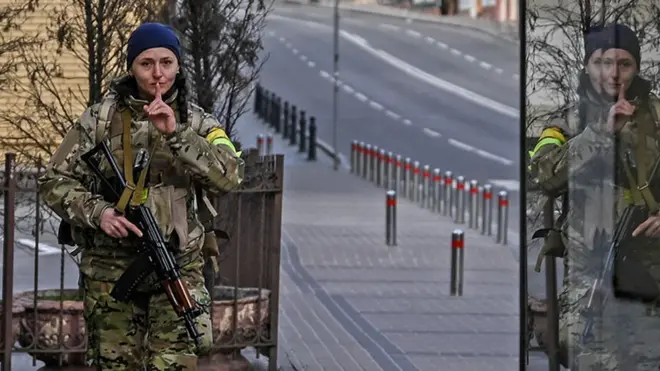 A member of Ukrainian forces patrols the streets at Maidan square