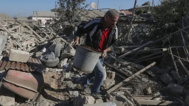 A man removes debris in the Nagorno-Karabakh capital, Stepanakert