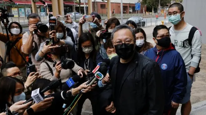 Veteran campaigner Benny Tai reports to police. He said his chances of bail were "not too great"