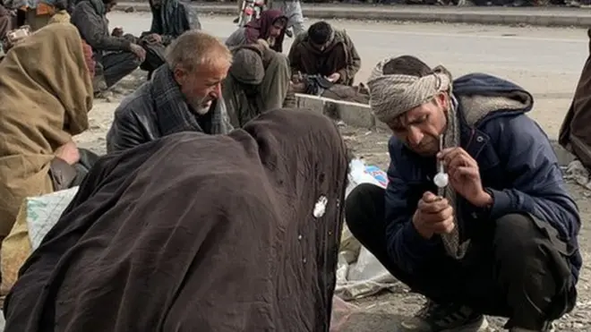 Drug users gather on the side of the road in the capital, Kabul