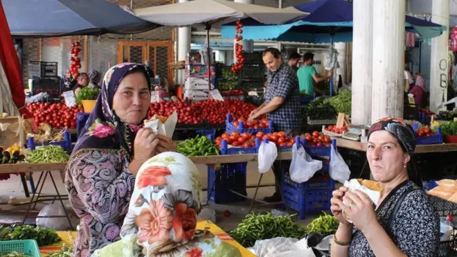 Dua perempuan terlihat menikmati makanan di sebuah pasar di Kota Sinop, Turki.