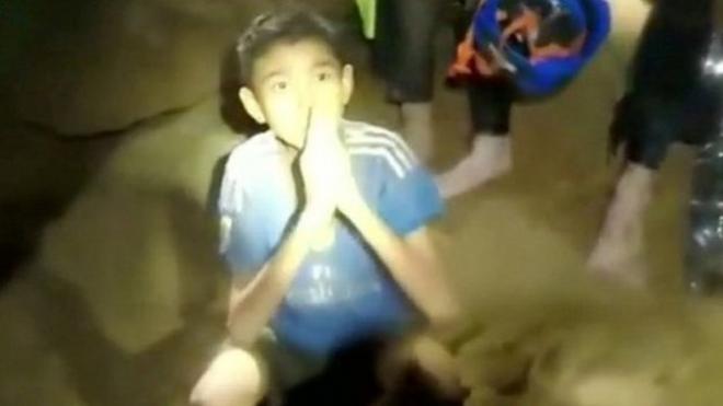 One of the boys trapped in a cave in Thailand greets rescuers