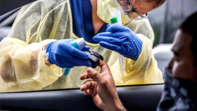 Heart rate and temperature checks take place ahead of coronavirus testing in Austin, Texas, 28 June 2020