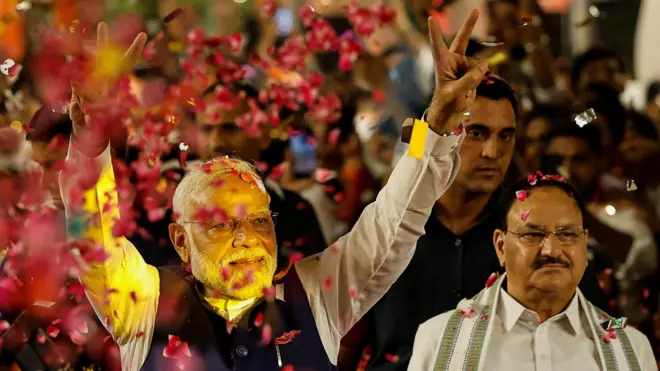 Supporters throw petals on Indian Prime Minister Narendra Modi as he arrives at Bharatiya Janata Party (BJP) headquarters in New Delhi on 4 June 2024