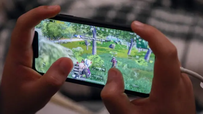 شاب يلعب على الهاتف