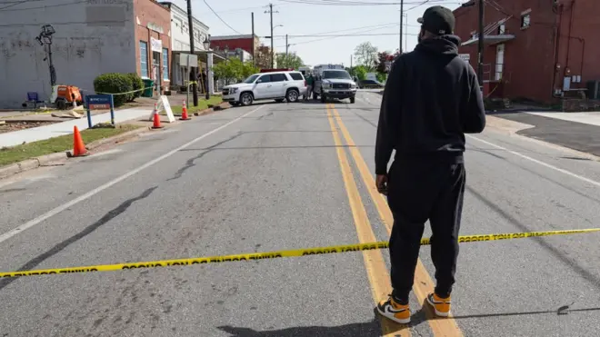 DJ Keenan Cooper looks at the scene following a shooting that took place Saturday night at the Mahogany Masterpiece dance studio in Dadeville, Alabama