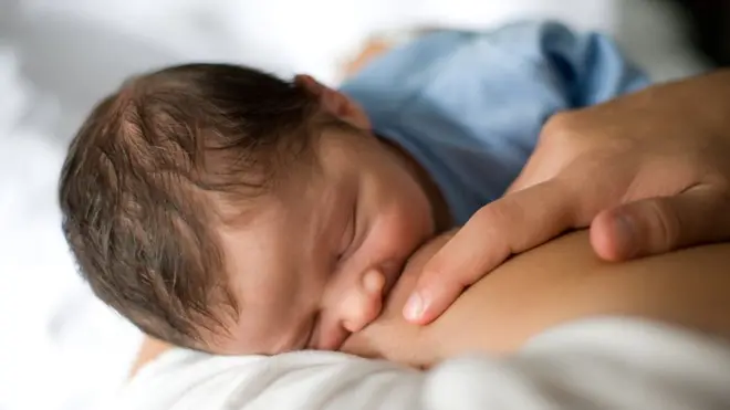 A photo of a baby being breastfed