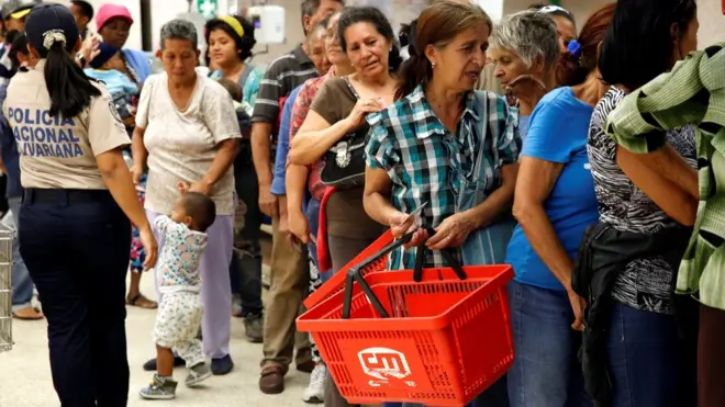 Queues are now commonplace outside the shops in Venezuela