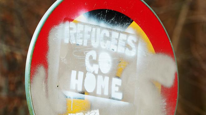 Sign saying 'Refugees go home'