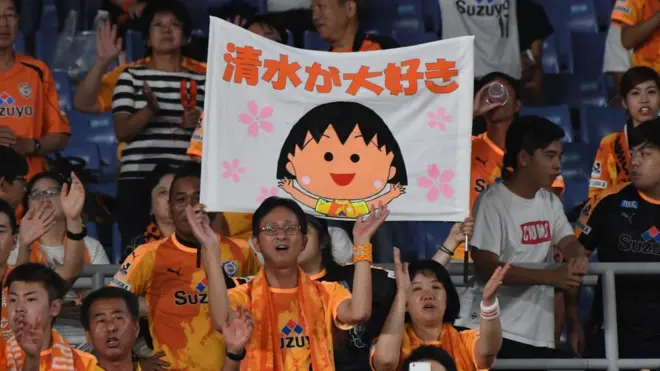 《樱桃小丸子》在外国受欢迎，在日本国内更是家喻户晓。图为日本球迷举起印有小丸子头像的横幅。