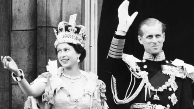 Queen Elizabeth II accompanied by Prince Philip waves to the crowd, 02 June 1953