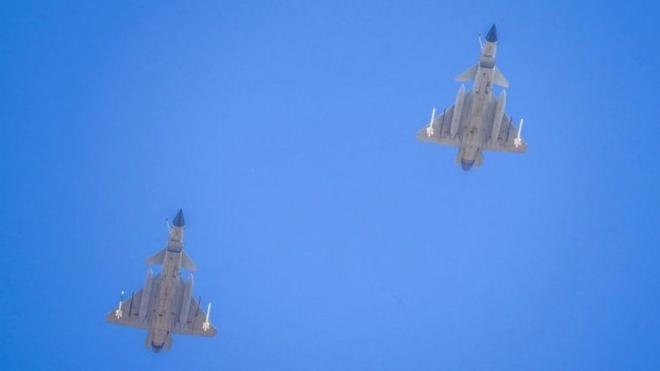 Two J-16 air fighters fly over a training base of PLA's naval aviation force in Ningbo in east China's Zhejiang province