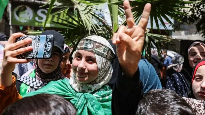 Palestinian supporters of Hamas celebrate after the ceasefire
