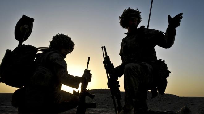 British soldiers pictured in silhouette during a dawn patrol in the Nahr-e Saraj district of Helmand Province, Afghanistan