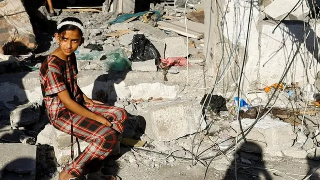 A Palestinian girl at the site of an Israeli strike on a house in Rafah