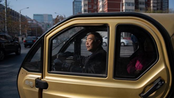 A man sits in an electric car in China