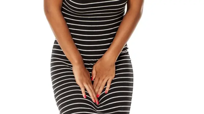 Une femme qui grimace de douleur