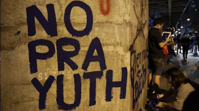 ผู้ชุมนุมกลุ่ม "ราษฎร" เขียนข้อความต่อต้าน พล.อ.ประยุทธ์ ระหว่างการชุมนุมที่แยกราชประสงค์และสำนักงานตำรวจแห่งชาติเมื่อวันที่ 18 พ.ย.