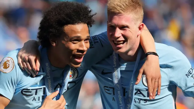 Leroy Sane and Kevin de Bruyne celebrate winning the Premier League with Manchester City