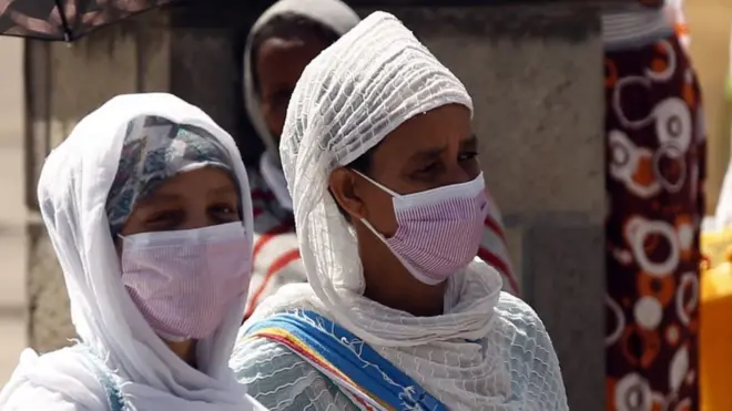 Deux femmes portant chacune un masque pour prévenir le Covid-19