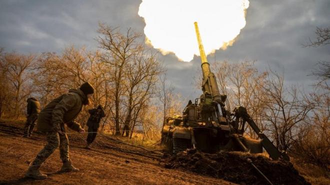 Ukrainian servicemen fire a self-propelled gun on a front line in Kherson region