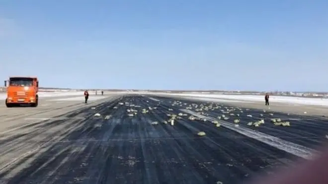 The precious cargo rained down on the runway