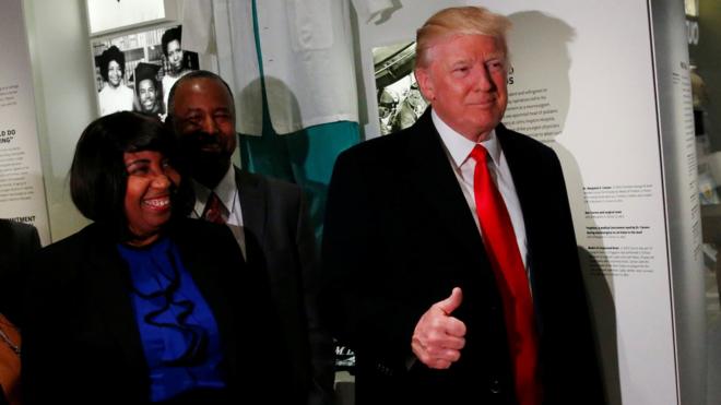 US President Donald Trump (R) gives the thumb-up while visiting the National Museum of African American History and Culture in Washington