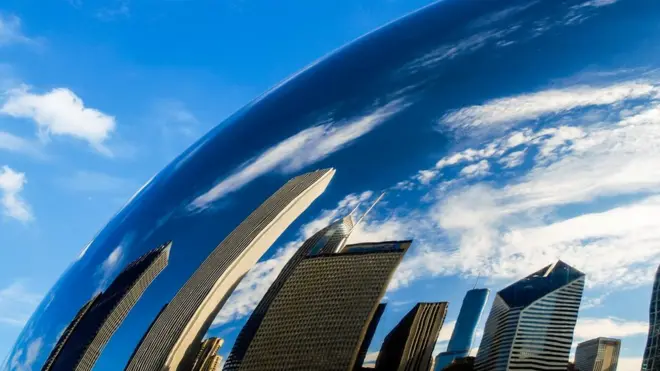 Одраз Чикага у статуи познатој као „зрно пасуља", која се налази Миленијум парку у центру града