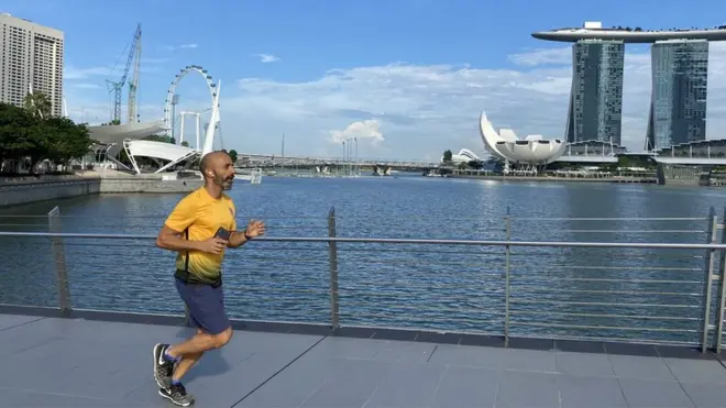 The BBC's Justin Harper testing out a running app in Singapore
