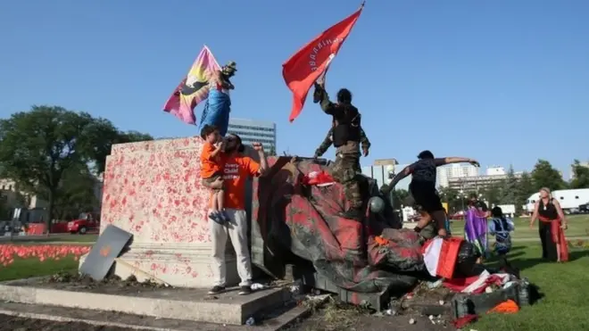 The statue was covered in red paint before protesters pulled it down with ropes