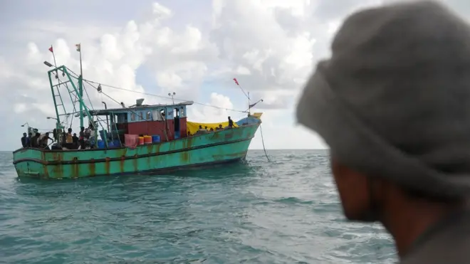 This picture taken on June 11, 2016 shows migrants from Sri Lanka on board a boat off the coast of Banda Aceh. Dozens of Sri Lankan immigrants bound for Australia were stranded off Aceh in northwest Indonesia after their boat broke down, local officials said on June 12. / AFP / CHAIDEER MAHYUDDIN (Photo credit should read CHAIDEER MAHYUDDIN/AFP/Getty Images)