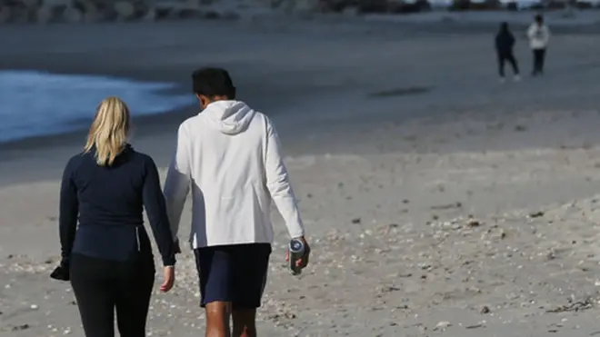 People walking on a beach in New Zealand