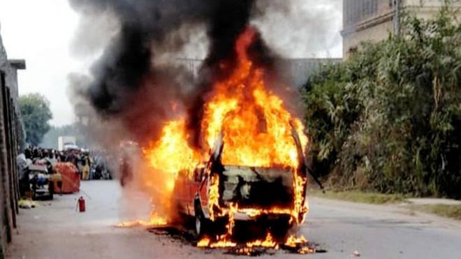 A burning vehicle in a street