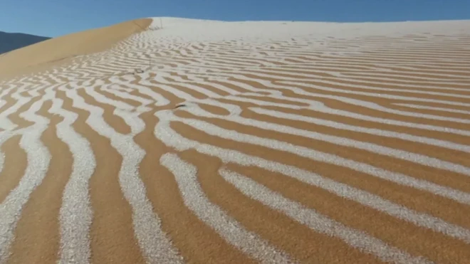 ริ้วน้ำแข็งปกคลุมเนินทรายในทางตะวันตกเฉียงเหนือของประเทศแอลจีเรีย