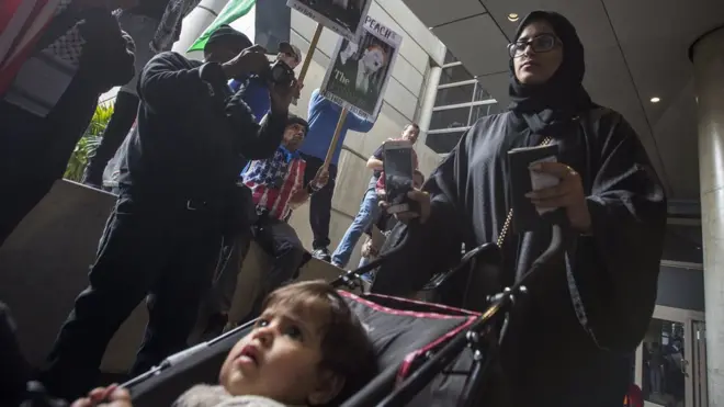 A woman and child pass at Los Angeles International Airport