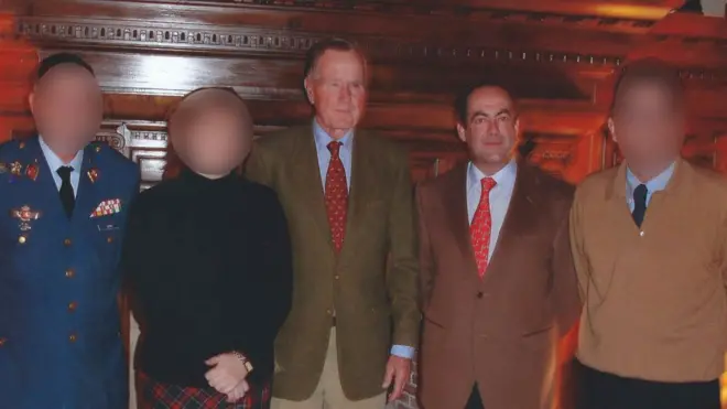 An interpreter, second left, says Mr Bush, centre, groped her in 2004