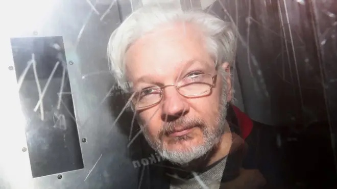 Assange pictured leaving court in January a year ago