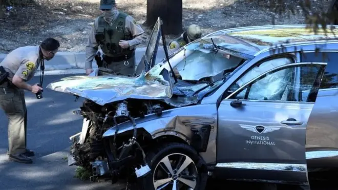 Los Angeles County Sheriff"s Deputies inspect the vehicle of golfer Tiger Woods, who was rushed to hospital after suffering multiple injuries, after it was involved in a single-vehicle accident in Los Angeles, California, U.S. February 23, 2021.